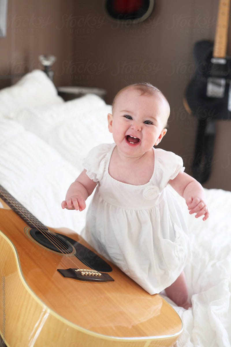 Happy Infant With Guitar