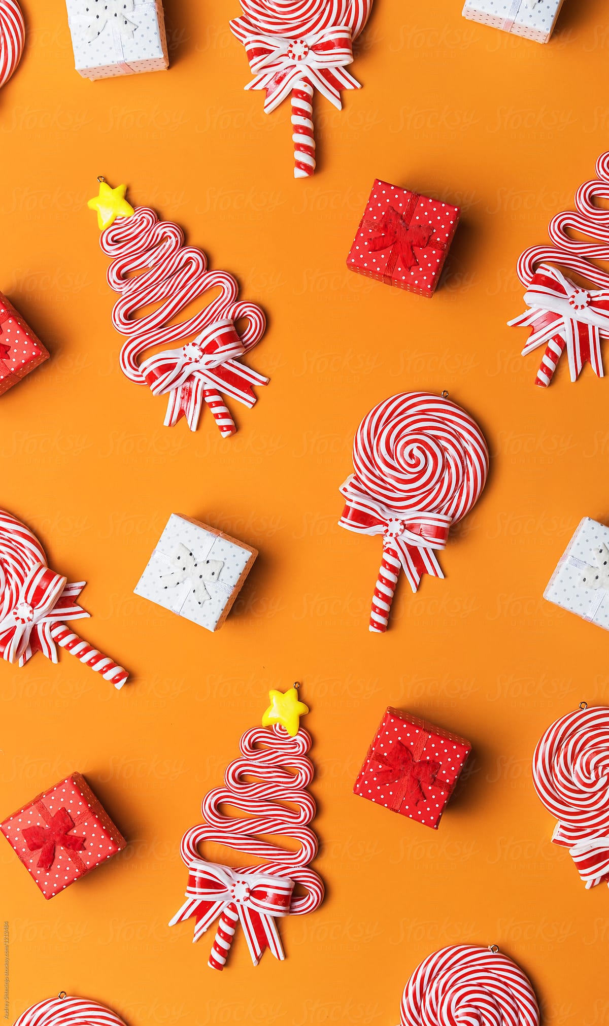 Various/Lollipop sweets decorations and small presents on orange background