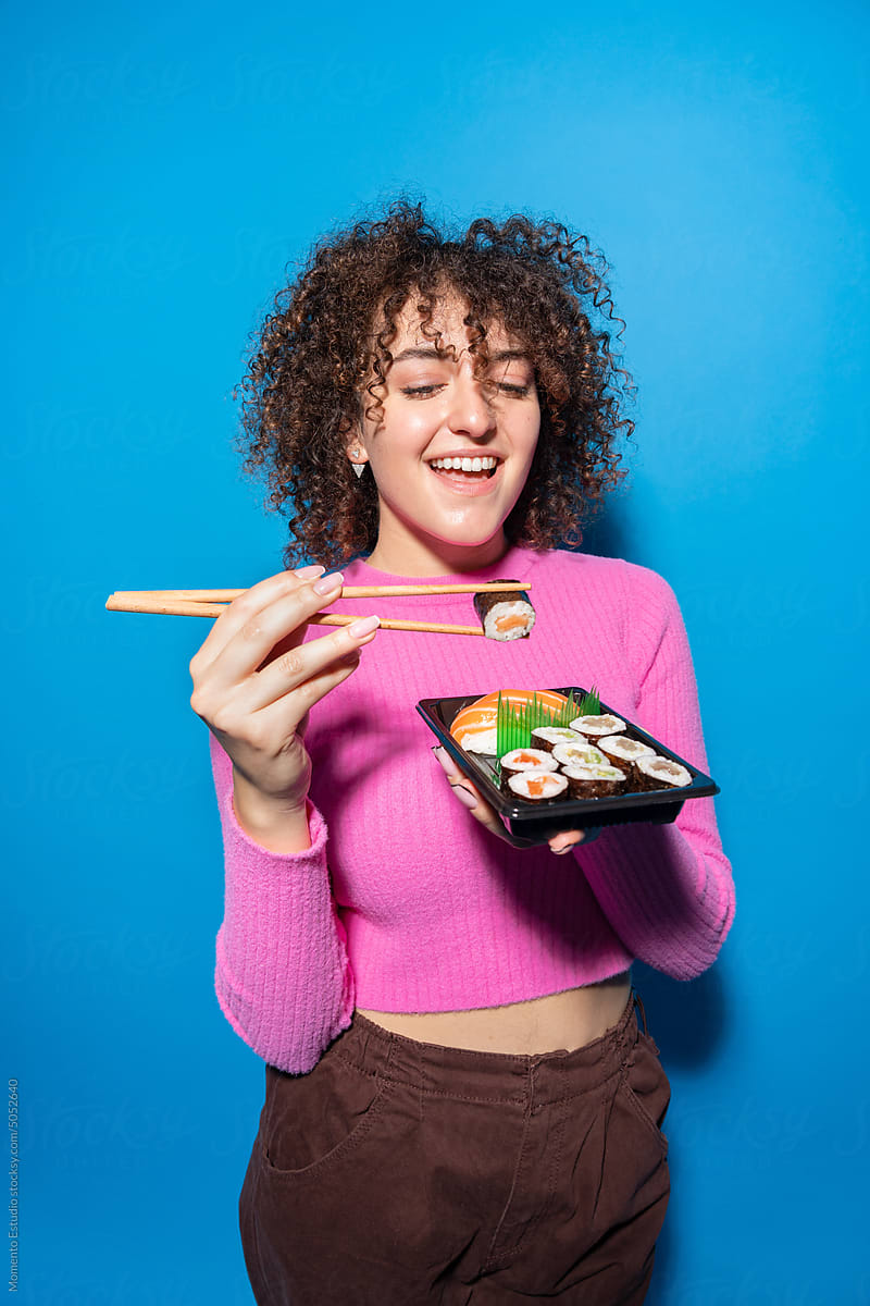 Woman eating  takeaway sushi