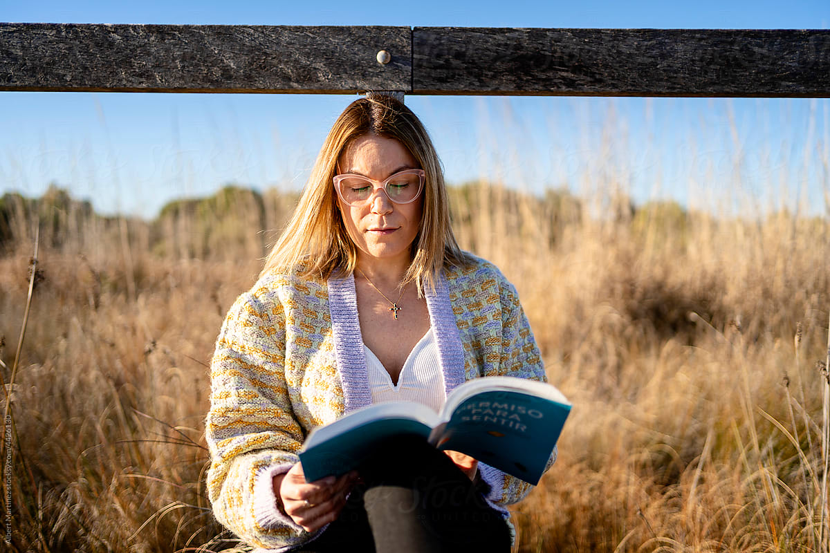 Woman reading book in countryside