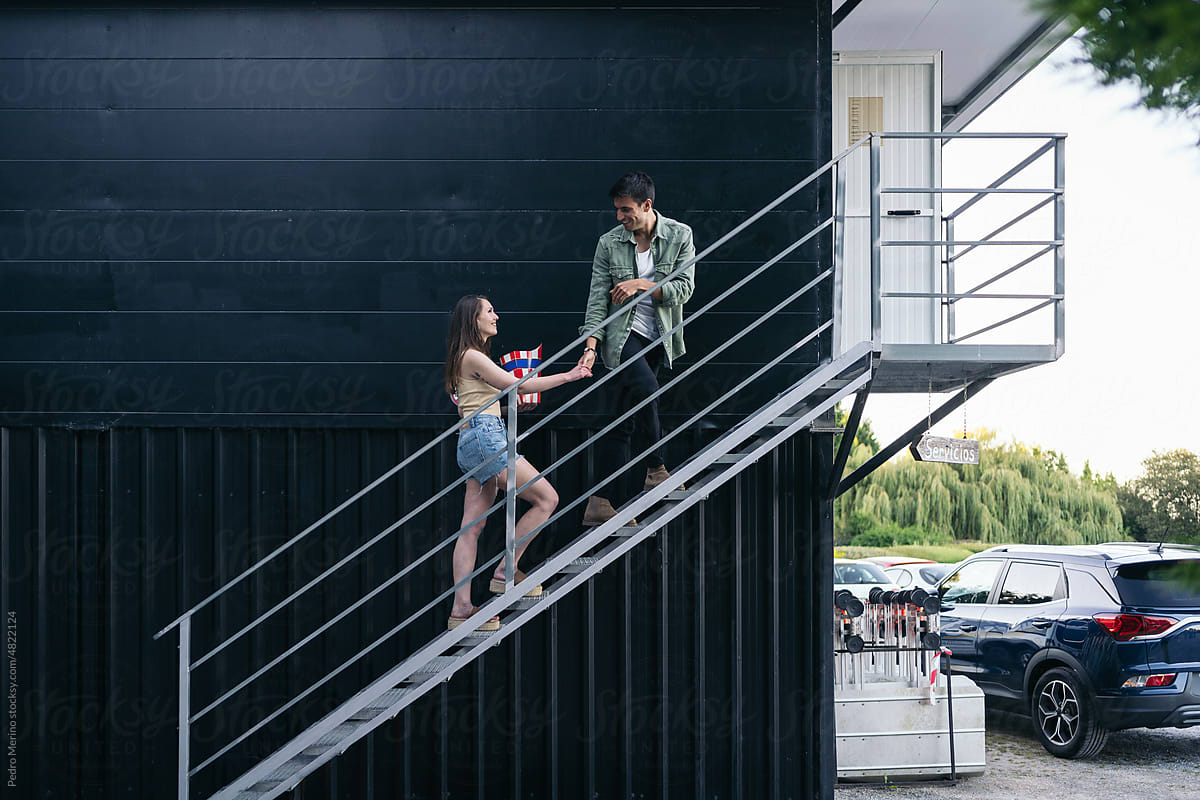 Couple climbing some stairs at an outdoors cinema
