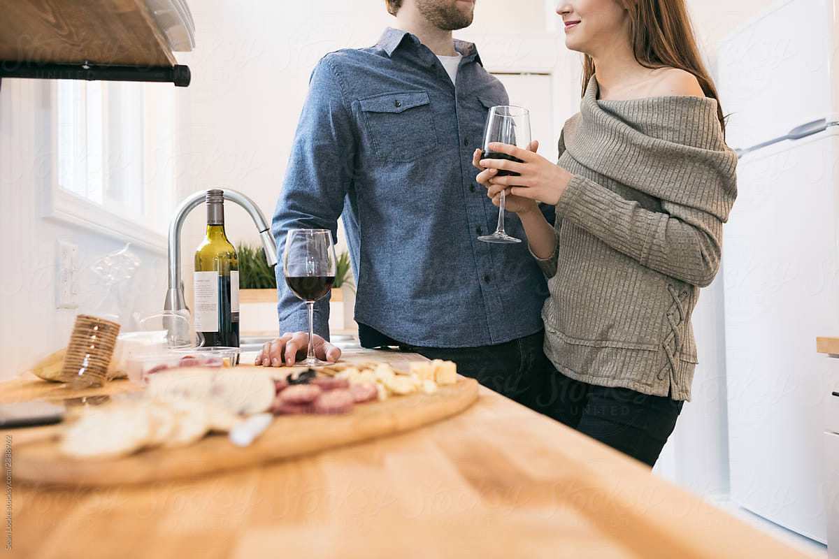 Home: Couple Enjoying Wine And Cheese In Tiny Home