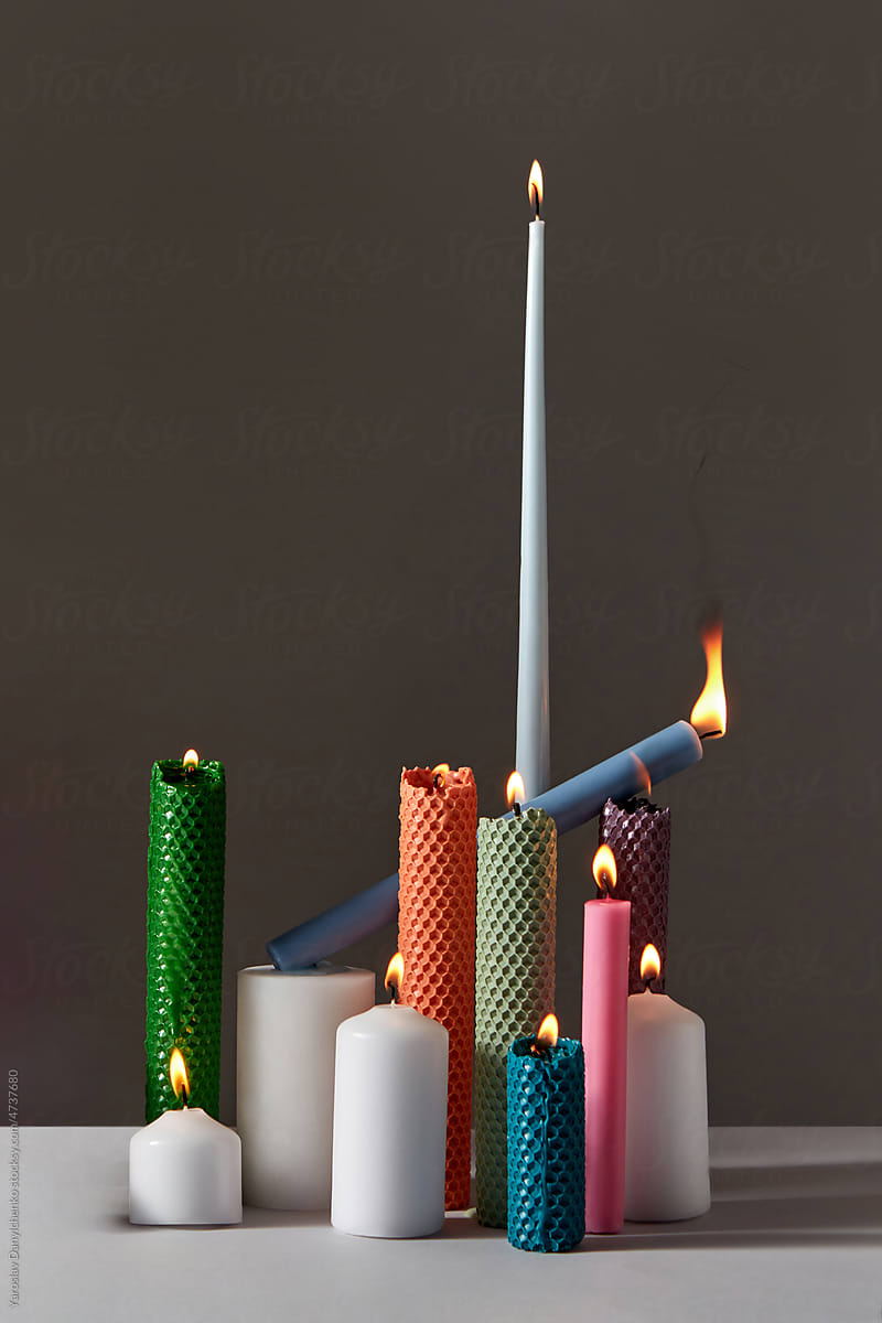 Handmade multi-colored candles in various shapes.