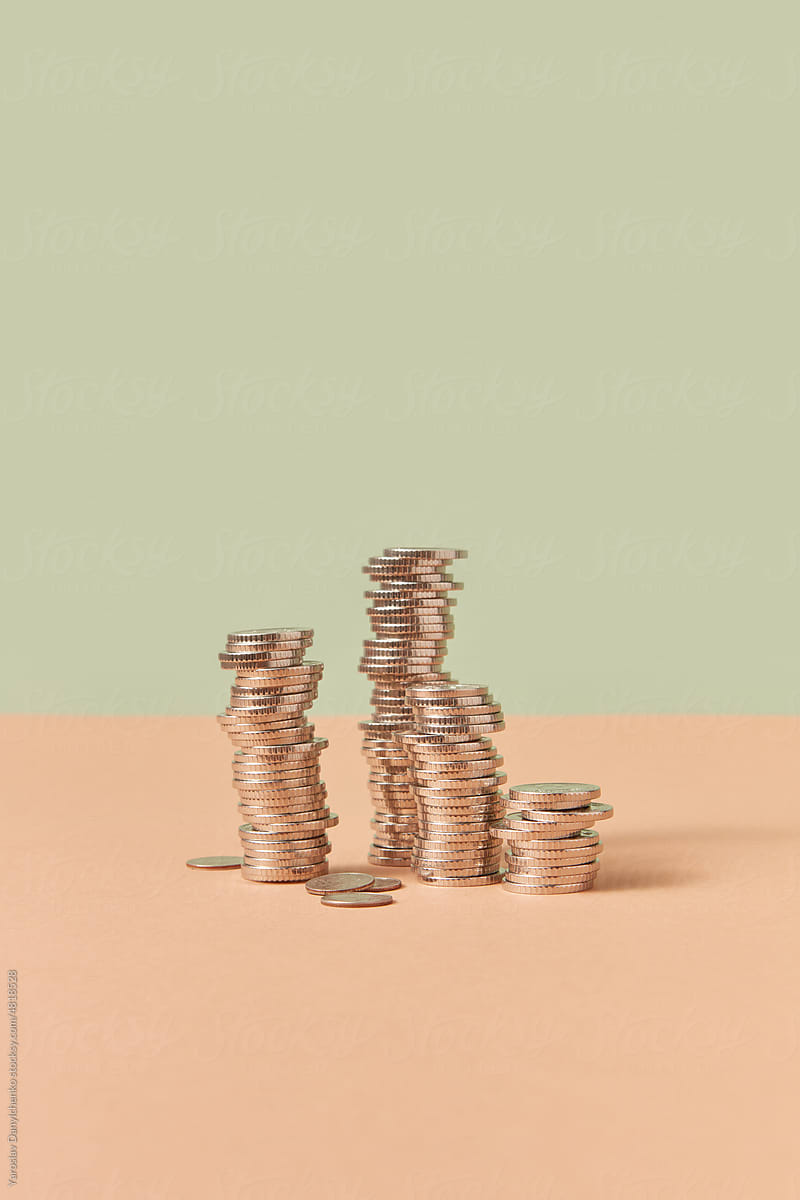 Stacks of cent coins on pastel background.