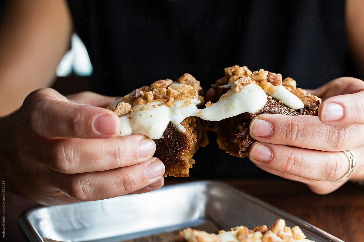 Hands pulling apart a dessert pastry