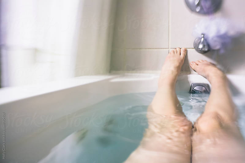 A Womans Legs And Feet In A Bathtub By Holly Clark Stock