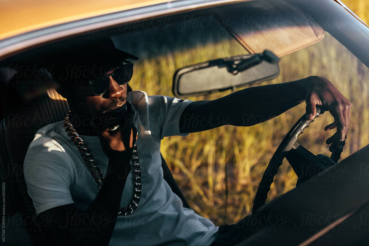 Black stylish man inside a car