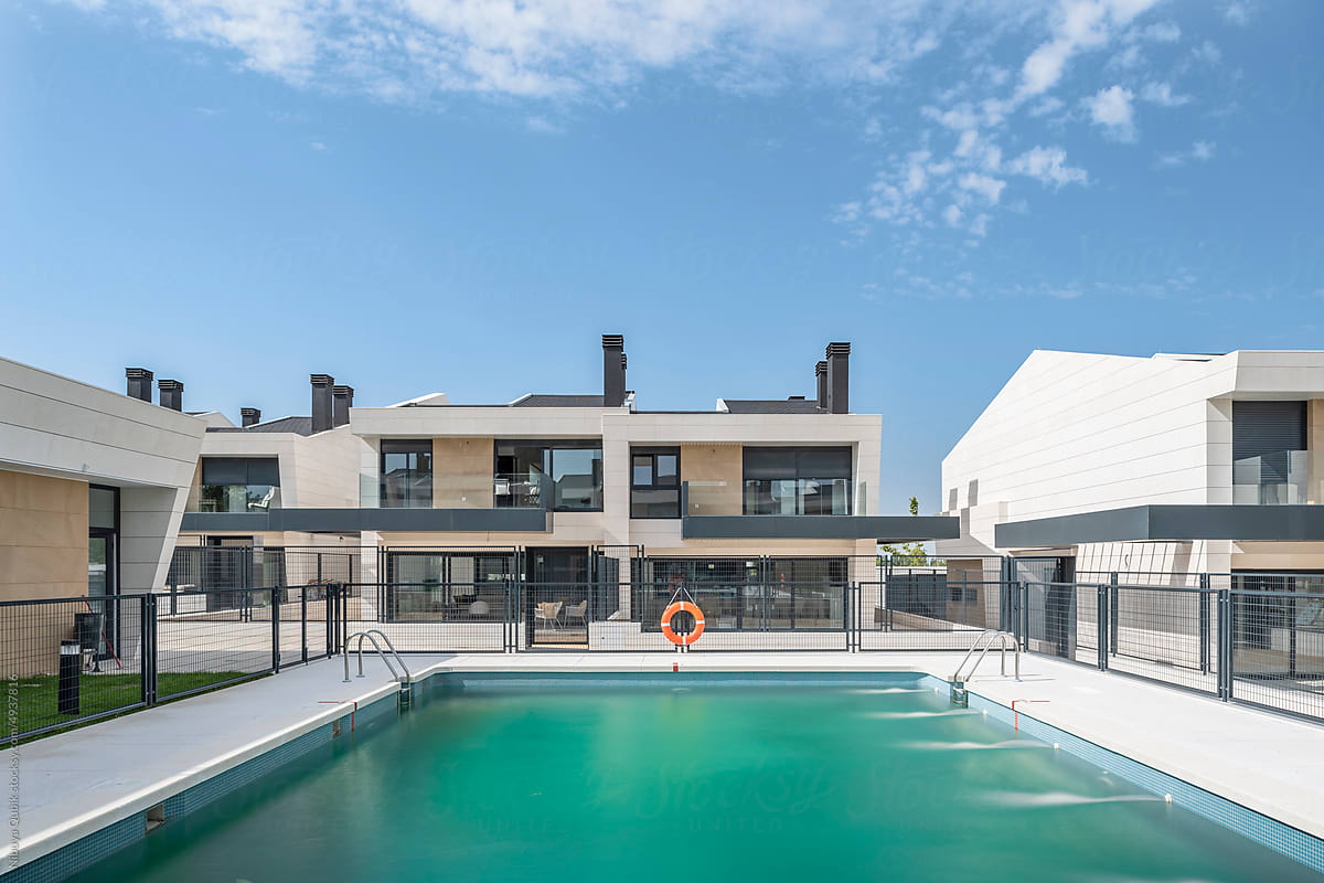 Modern luxury single-family terraced houses and the common pool at day