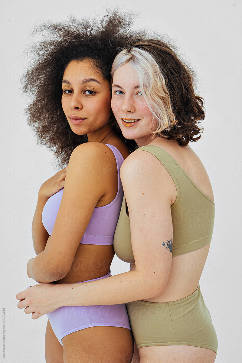 two women with different skin color hugging