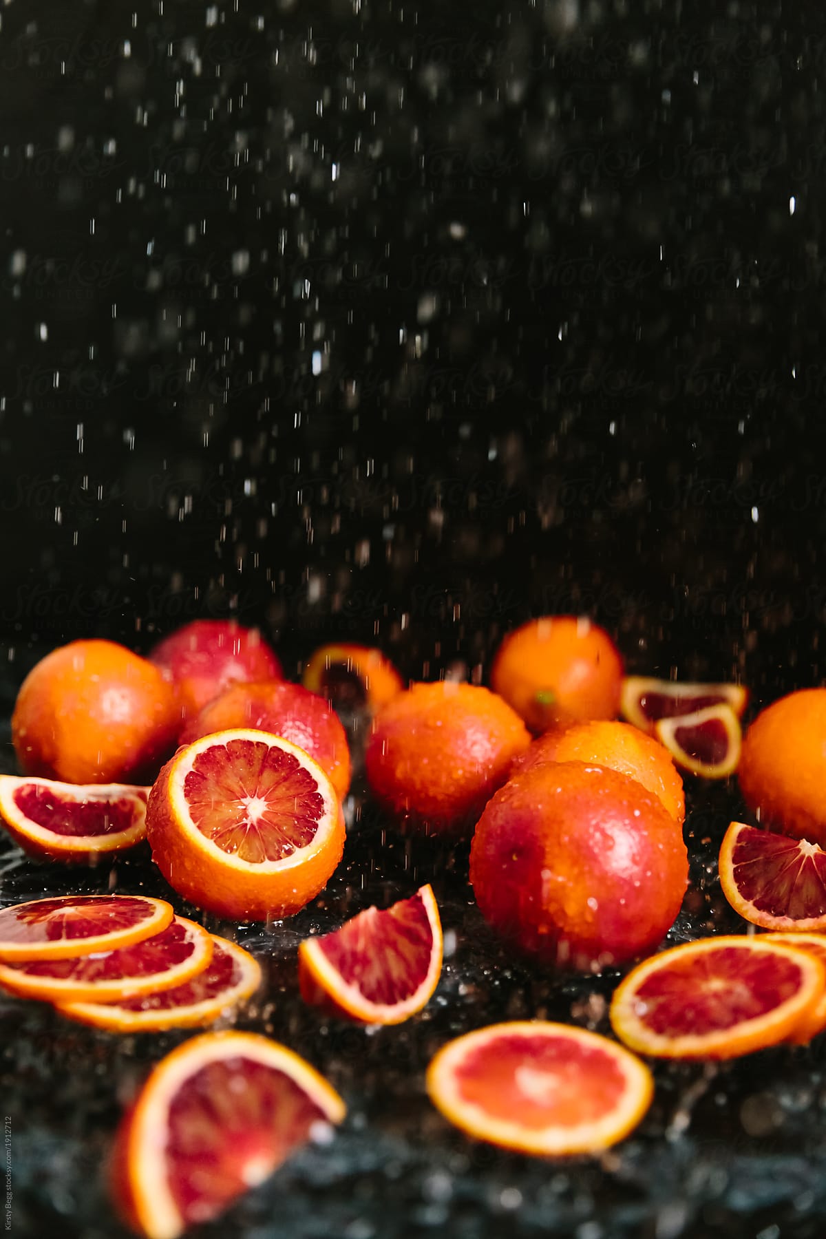 Water falling onto red oranges