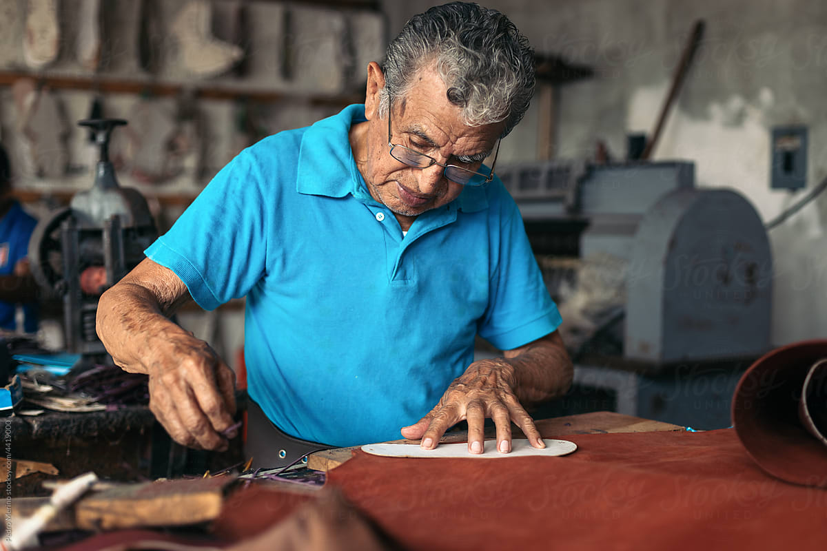Hispanic senior shoemaker working