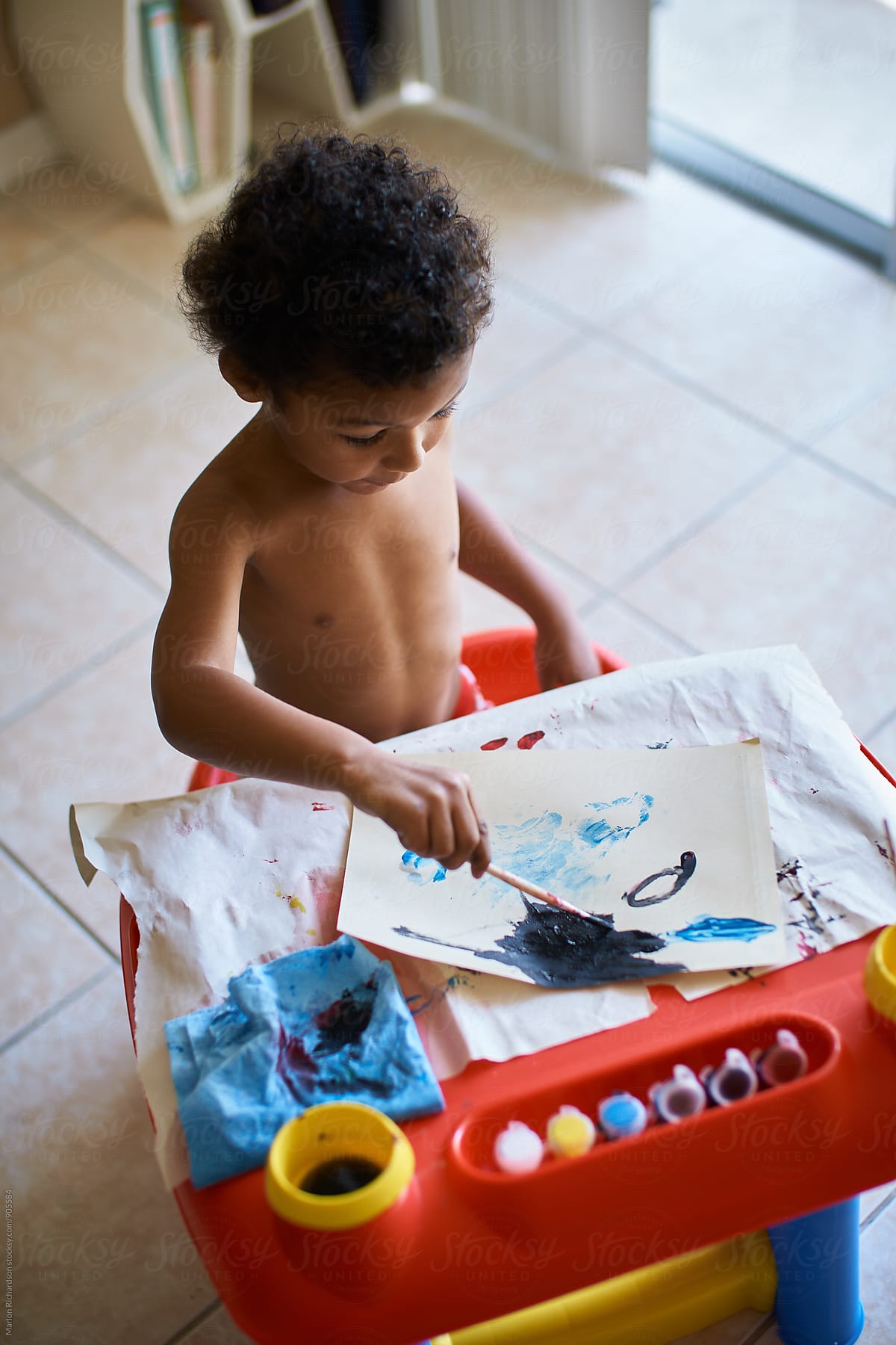 Mixed Race Toddler Painting by Stocksy Contributor Marlon
