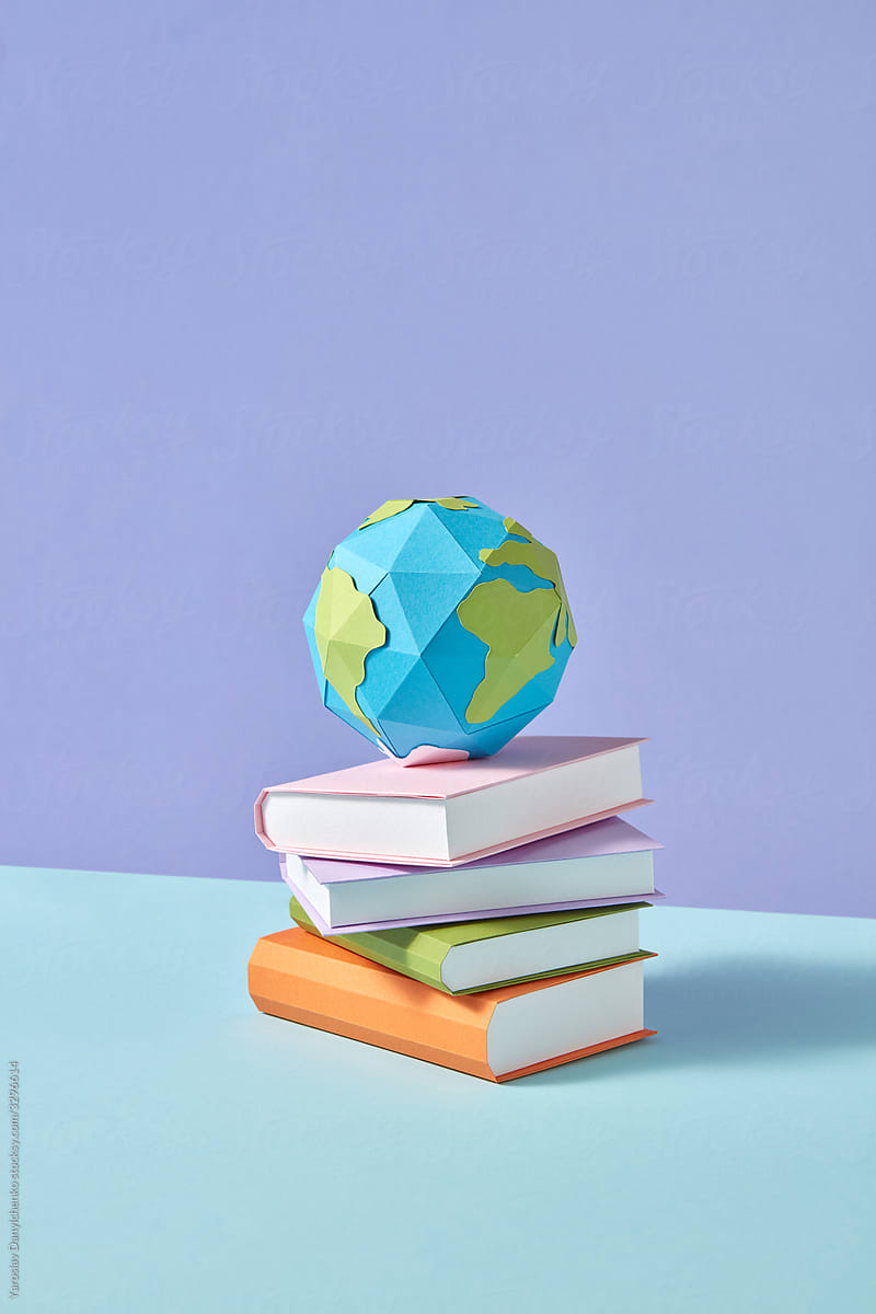 Papercraft stack of study books and Earth\'s globe.