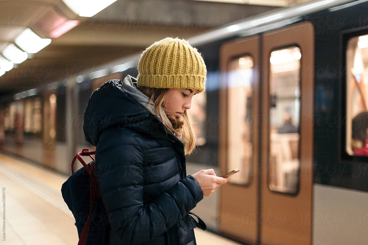 Woman texting at the station