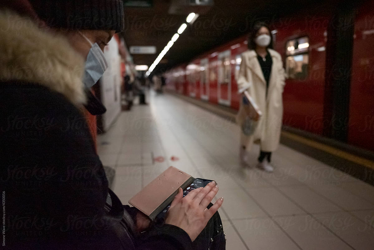 Woman using phone in the subway