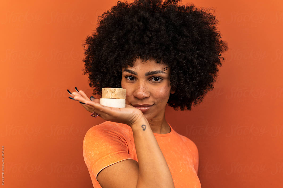 Hispanic woman smelling organic soap