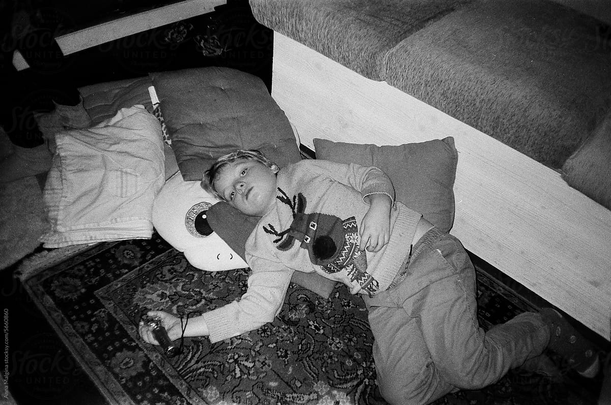 A kid on a new year party lying on a floor