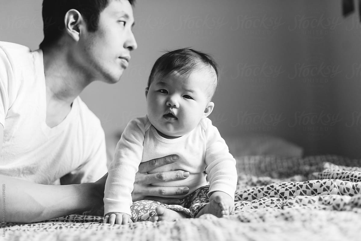 Dad holding baby in sitting position