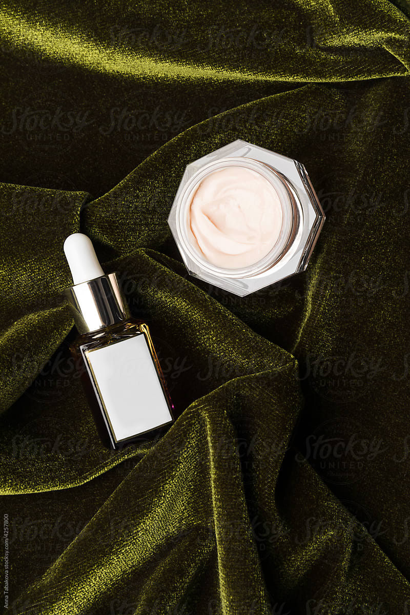 Beauty products on top of green velvet