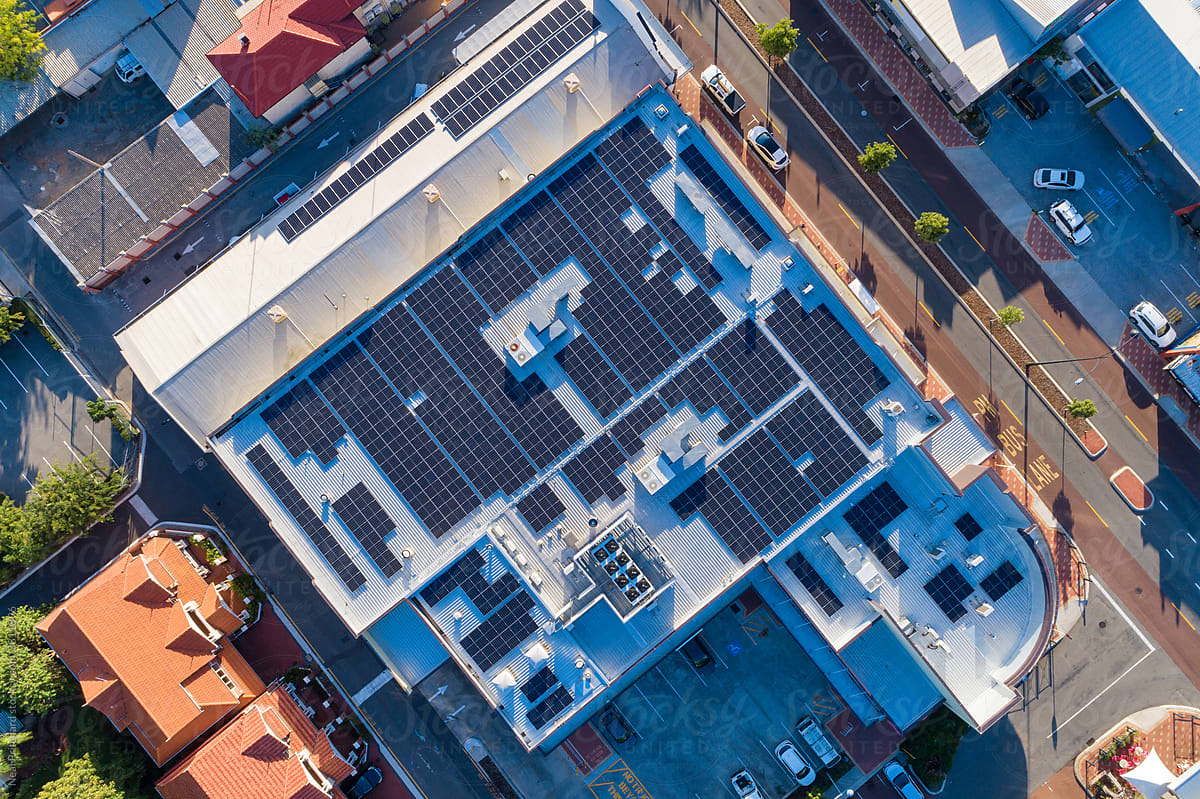 Aerial views over commercial building with over 600 solar panels installed