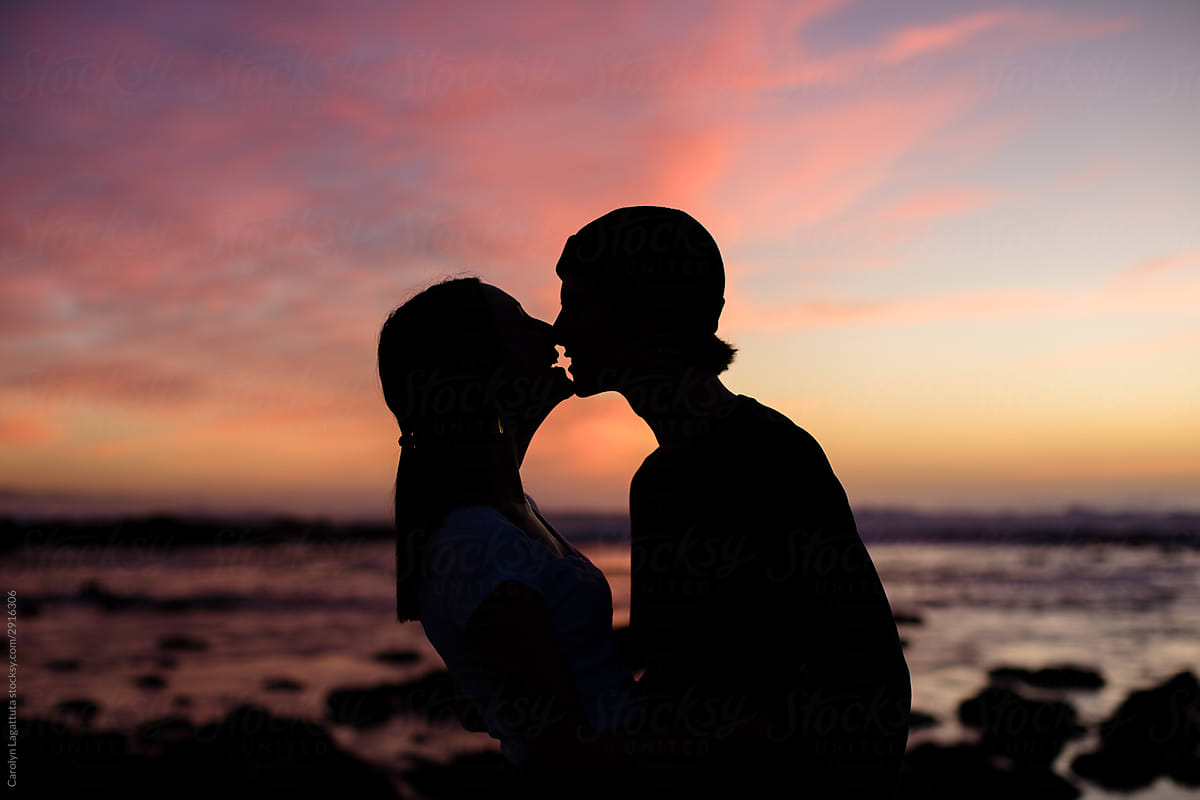 Teen Couple Kissing At Sunset By Stocksy Contributor Carolyn