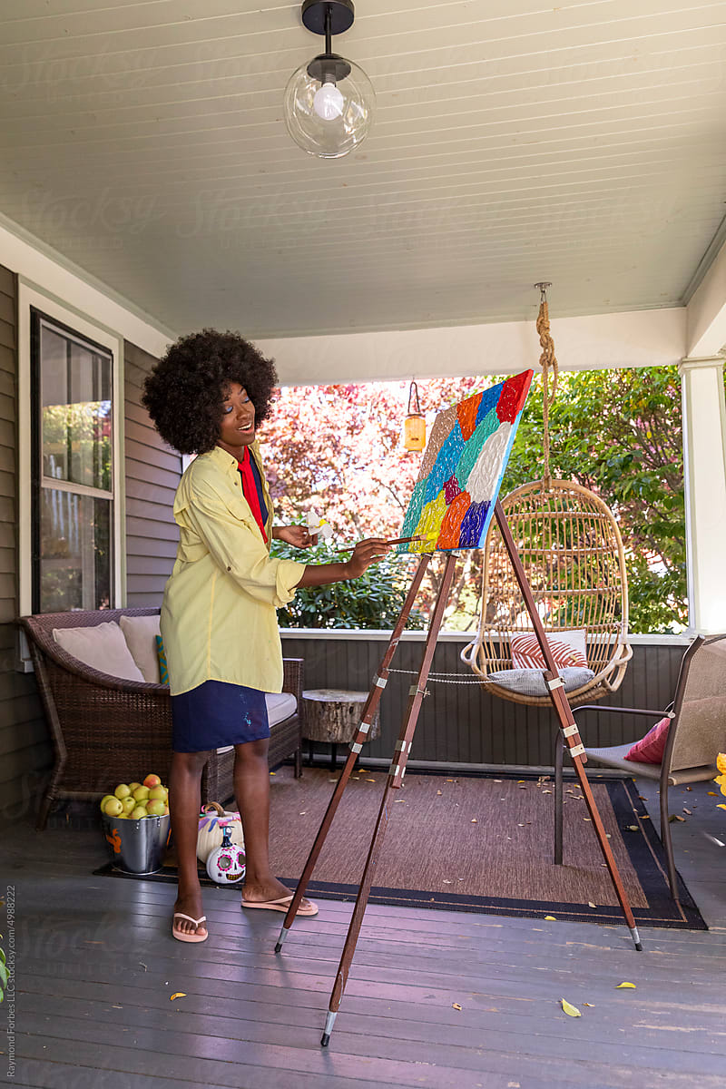 African American Lifestyle Girl artist Painting easel outdoors