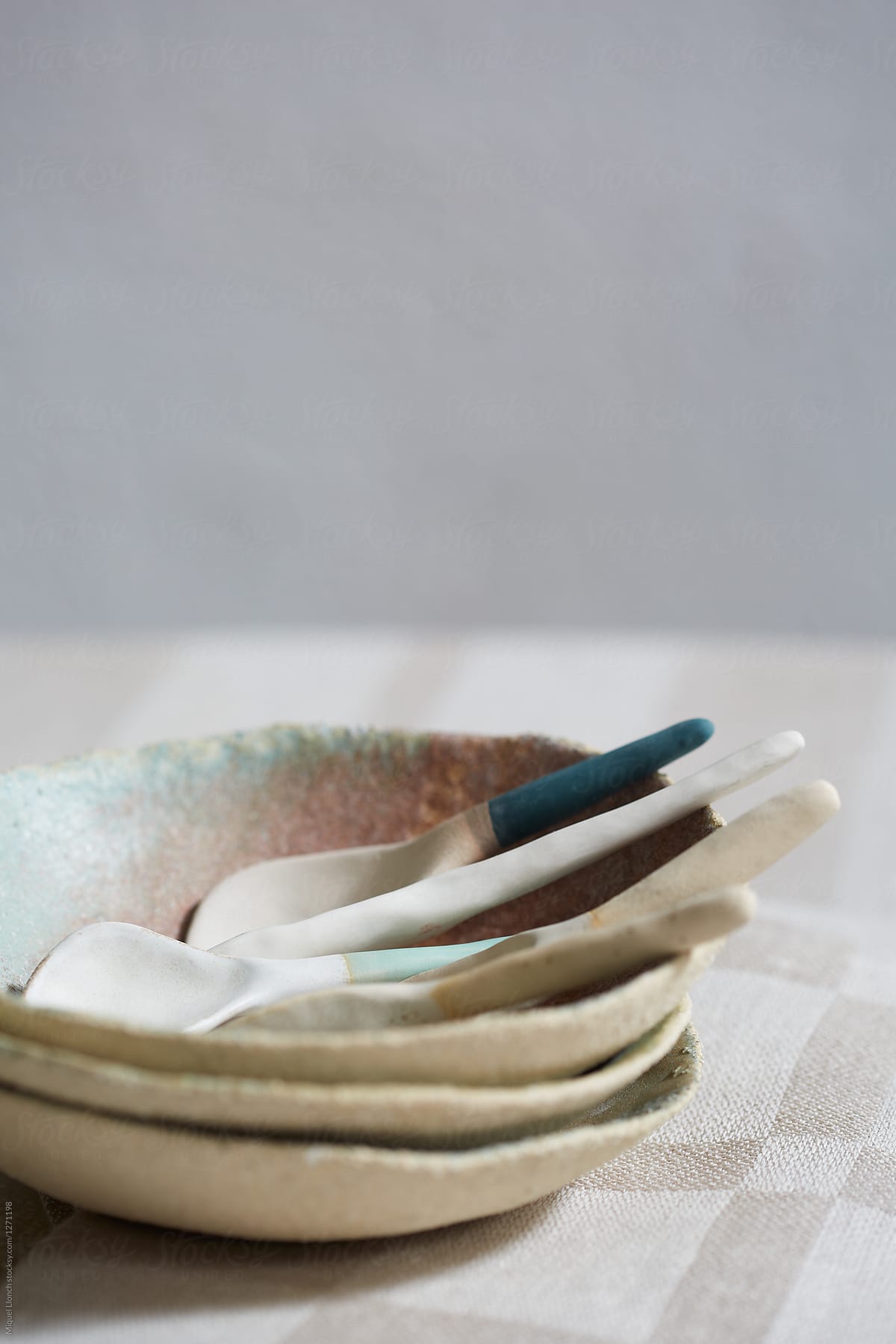 Detail of ceramic table ware with spoons and stacked bowls