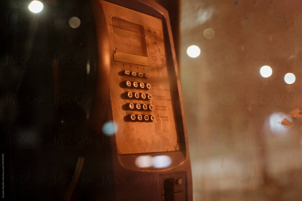 Old phone booth in dark street at night