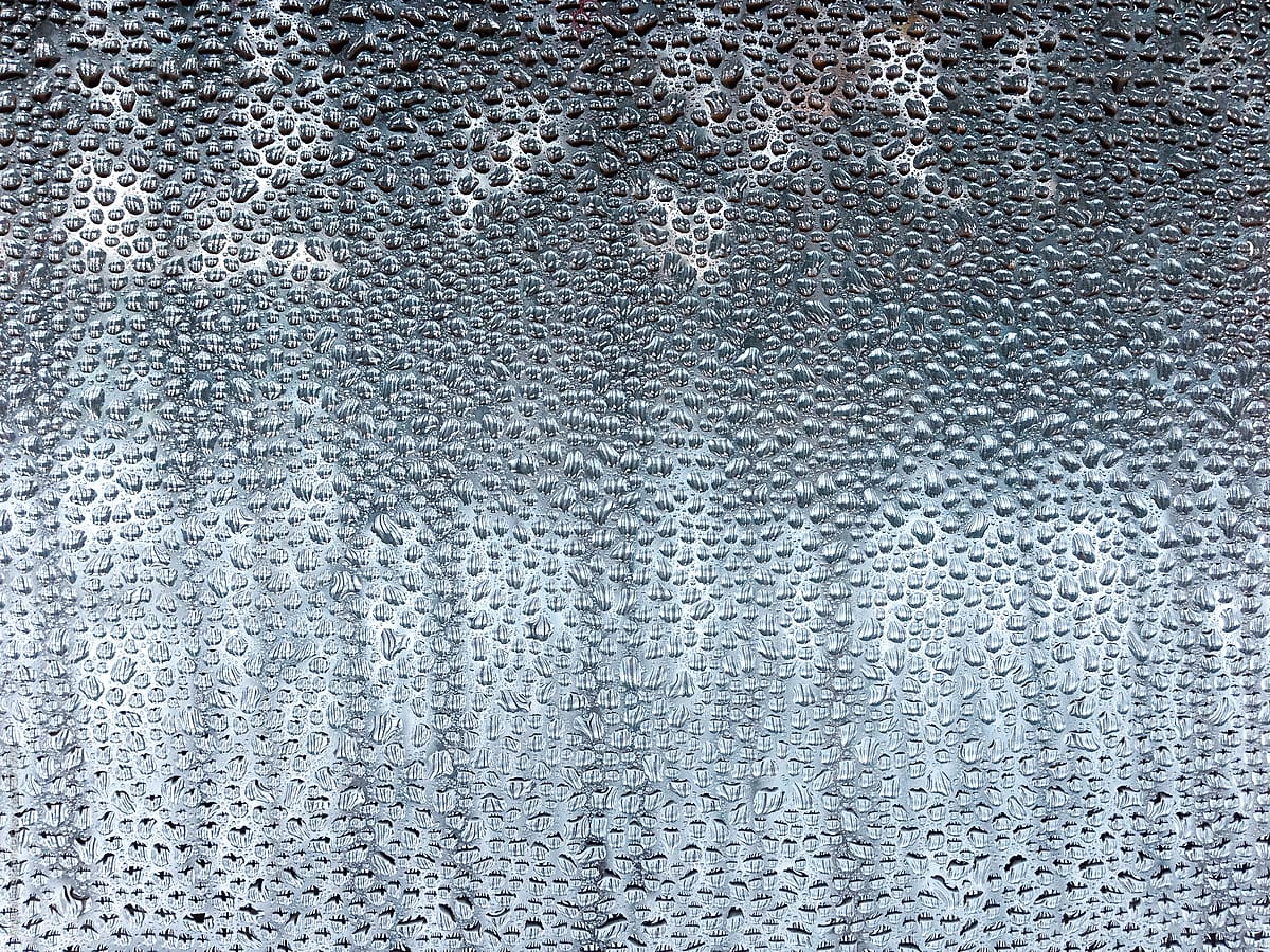 Water droplets from condensation on the inside of a window in winter