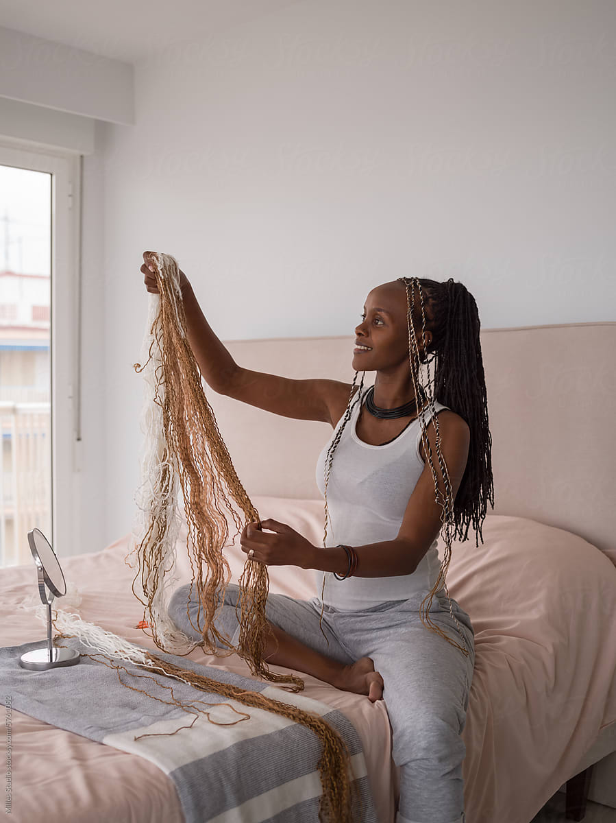 Woman looking at hair extensions at home