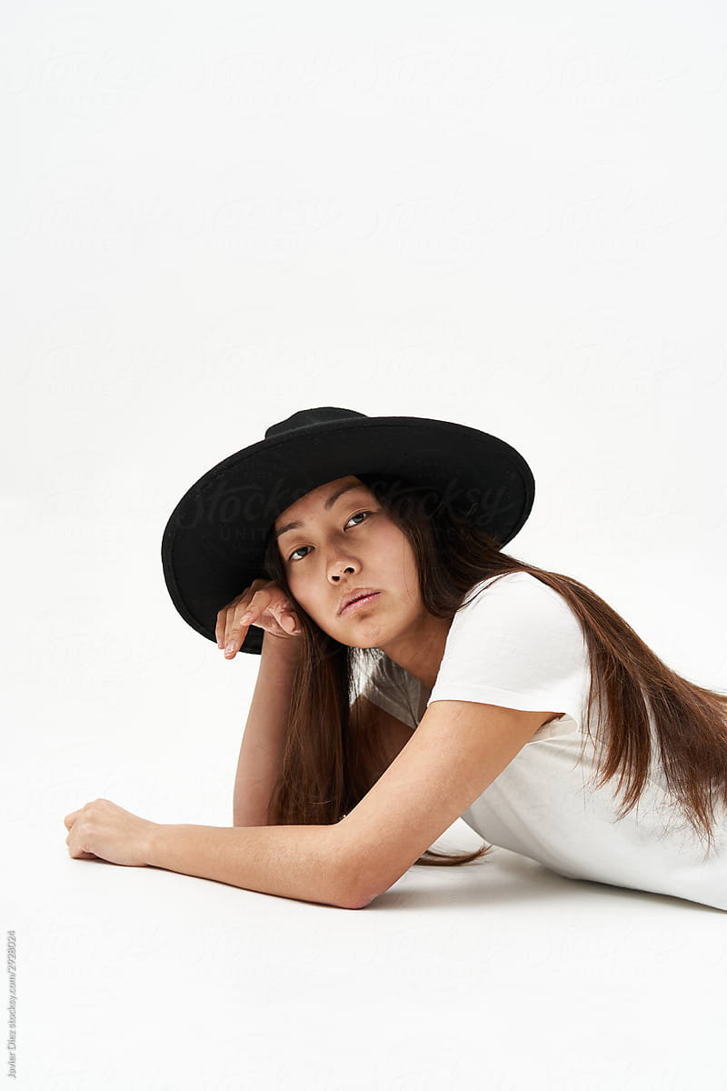 Asian woman in stylish hat looking at camera