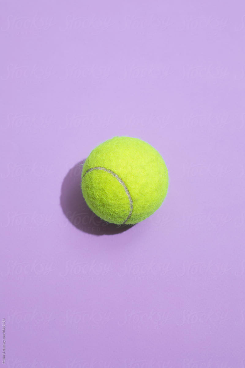 Tennis ball on a colorful background with hard lighting
