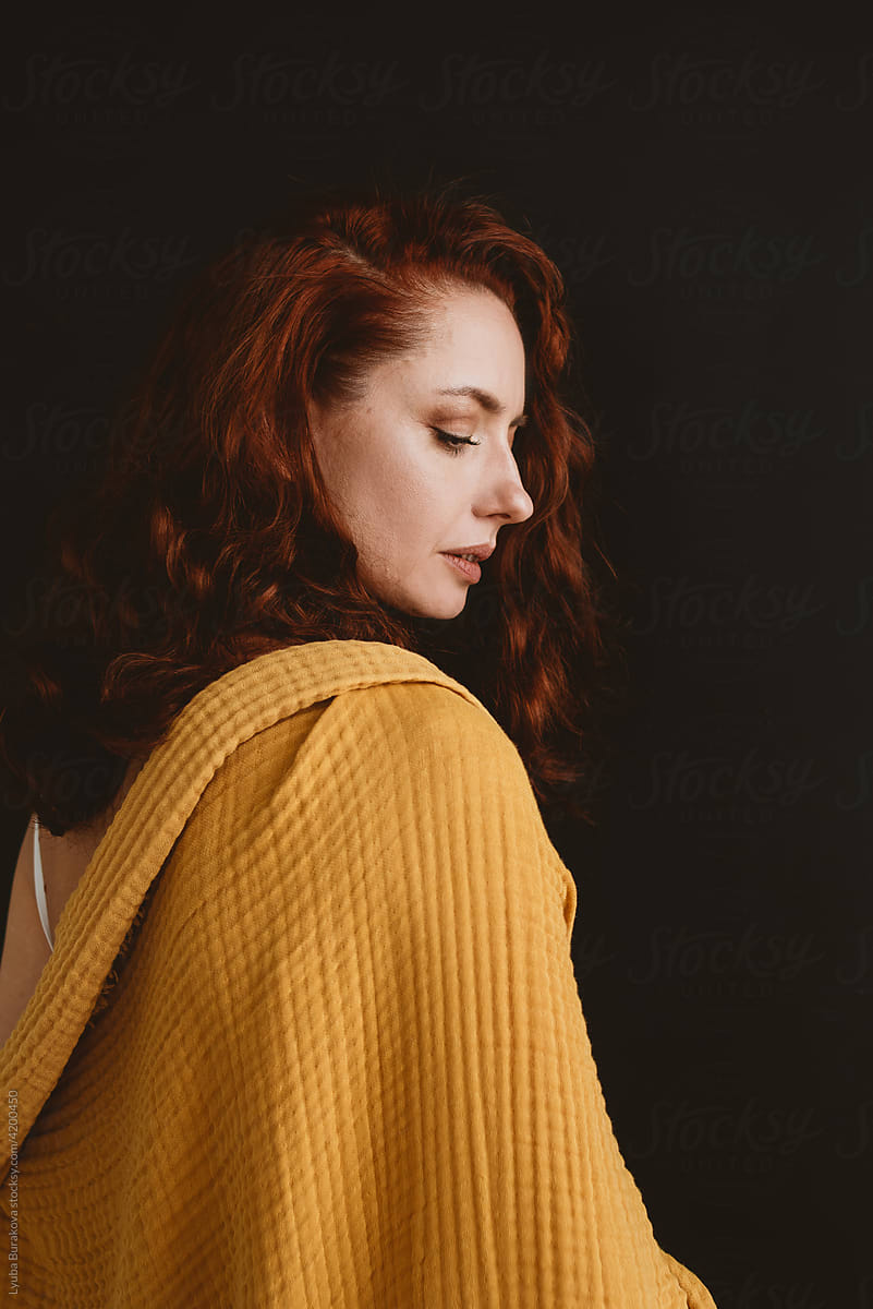 Woman covered with yellow plaid