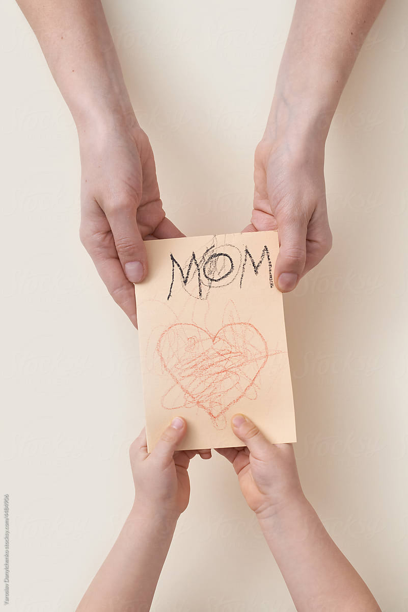 Mother receiving creative greeting card from child
