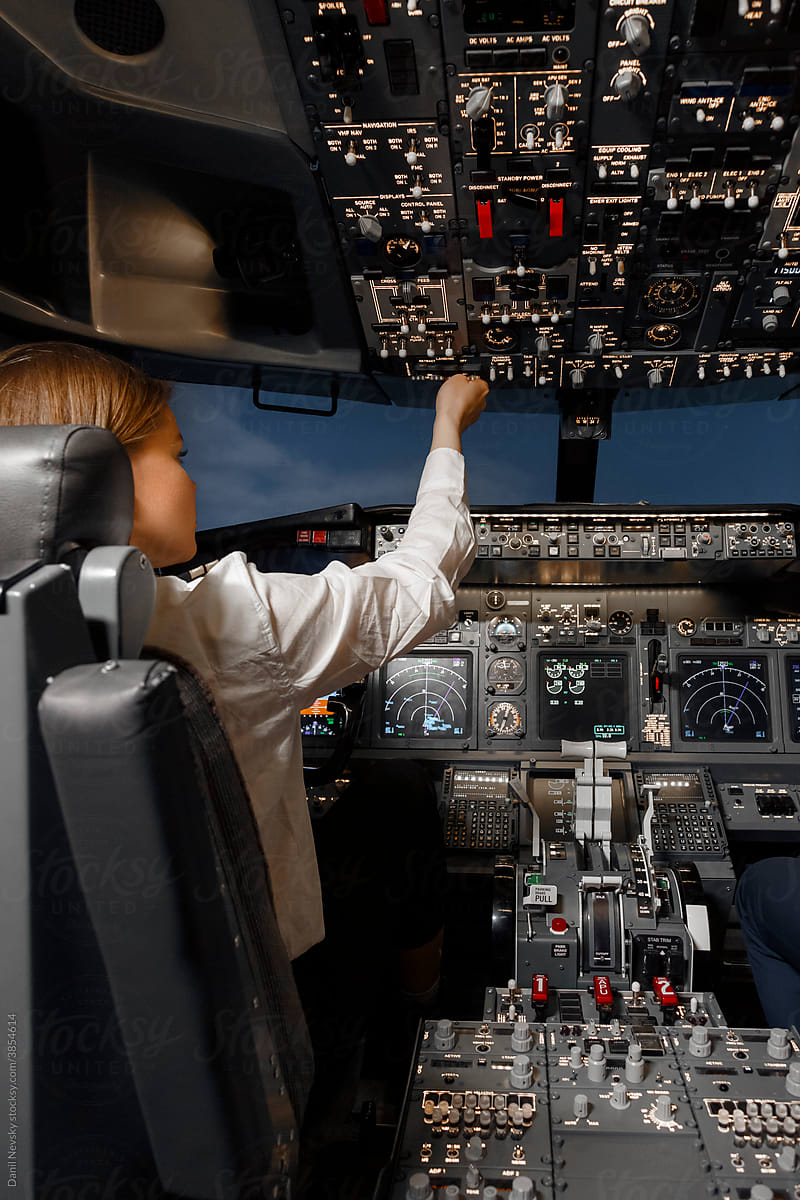 Female aviator controlling modern aircraft