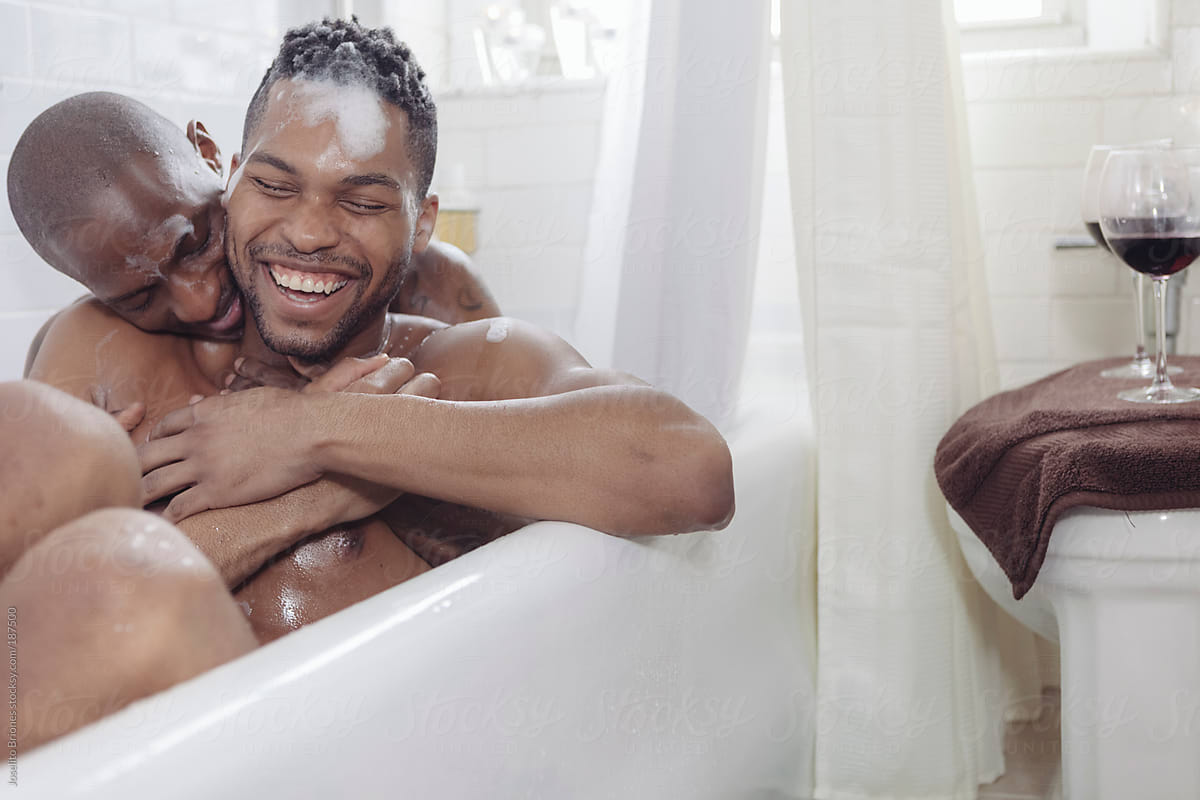Gay Couple Having Fun Bathing Together In A Bath Tub by Joselito Briones.