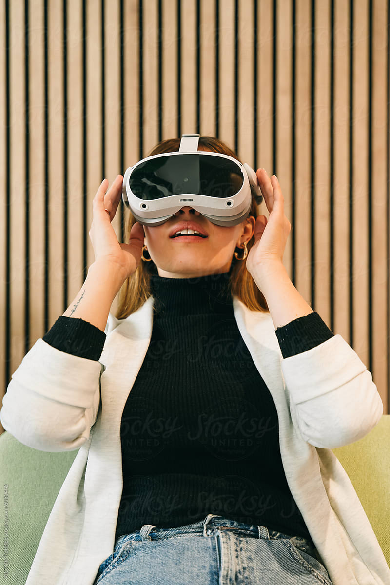 A woman is engaged with a virtual reality headset