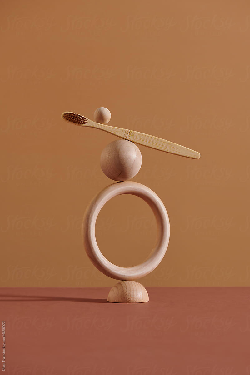Balancing bamboo or wooden toothbrush on wooden balls and wooden