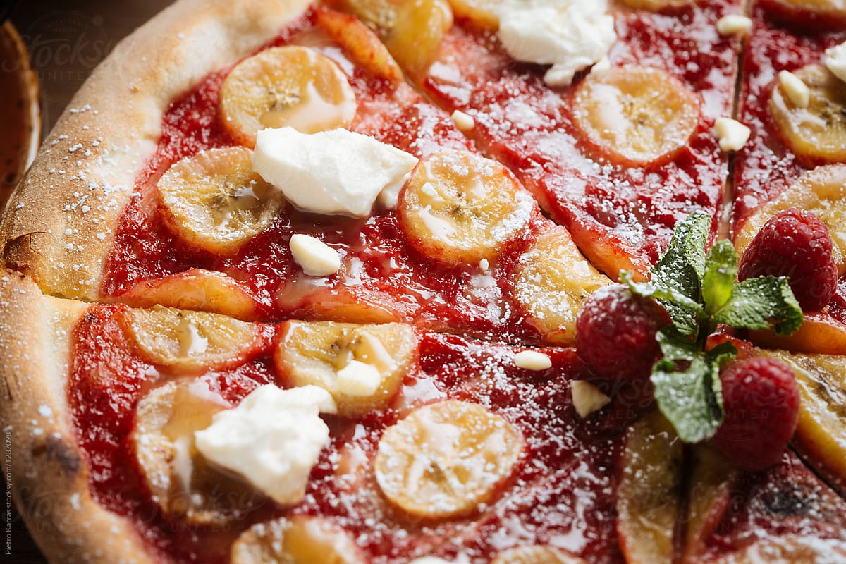 Sweet pizza with raspberry sauce and banana