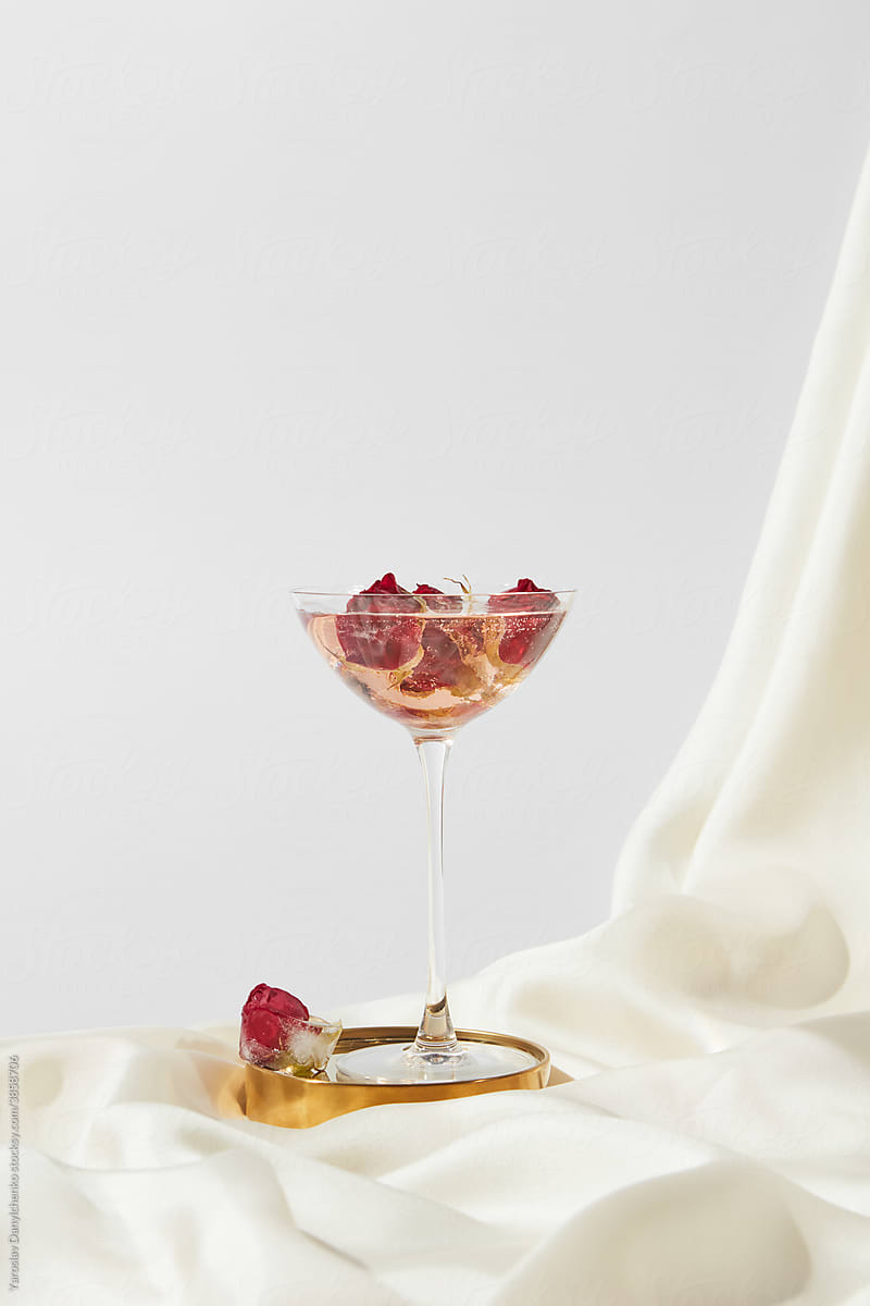 Glass with ice cubes and roses