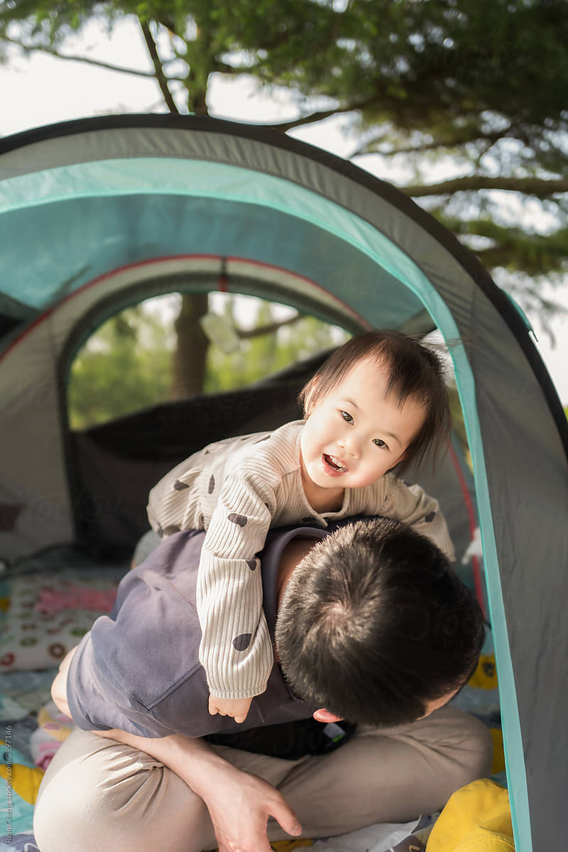 Asian father and daughter in tent