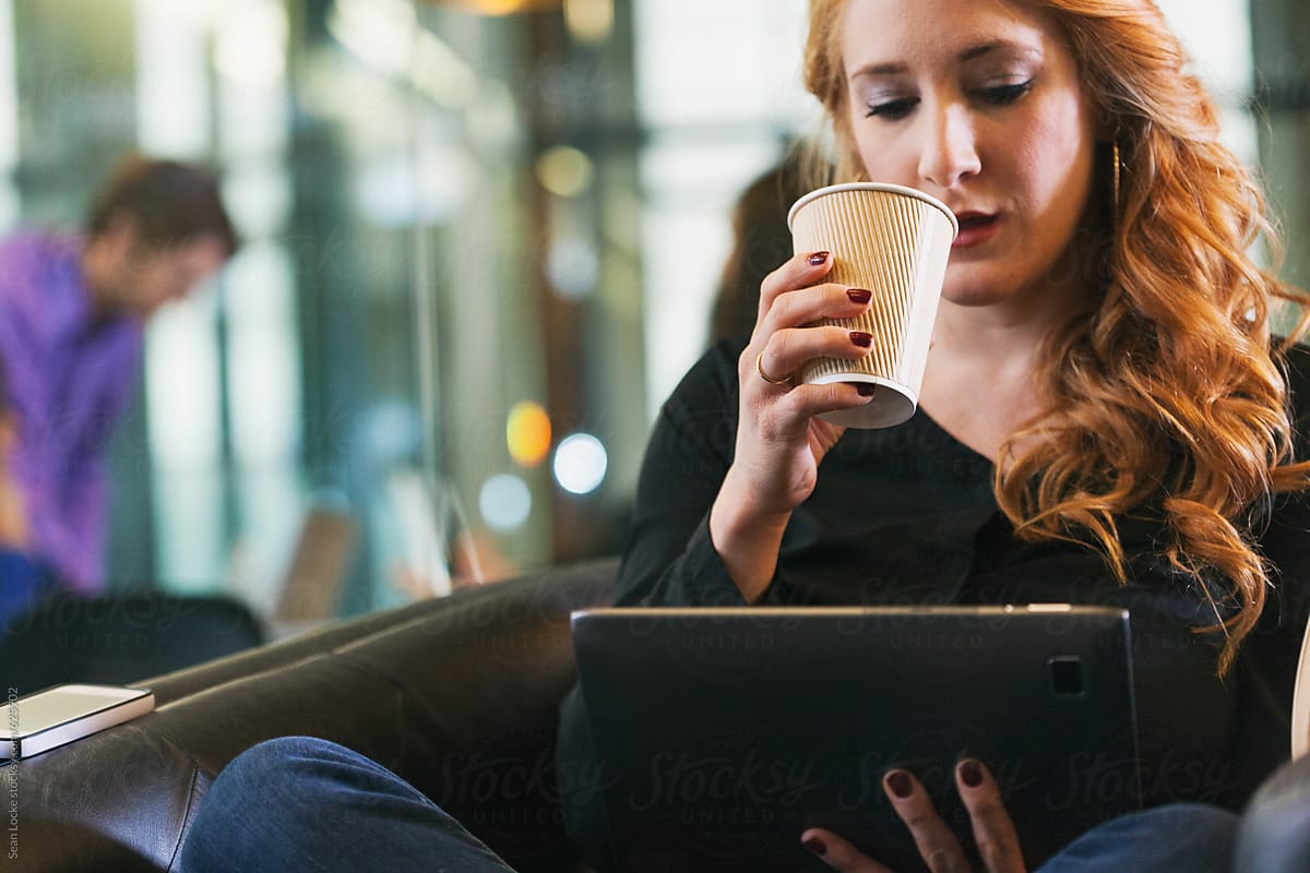 Office: Woman Sitting In Chair With Digital Tablet And Coffee