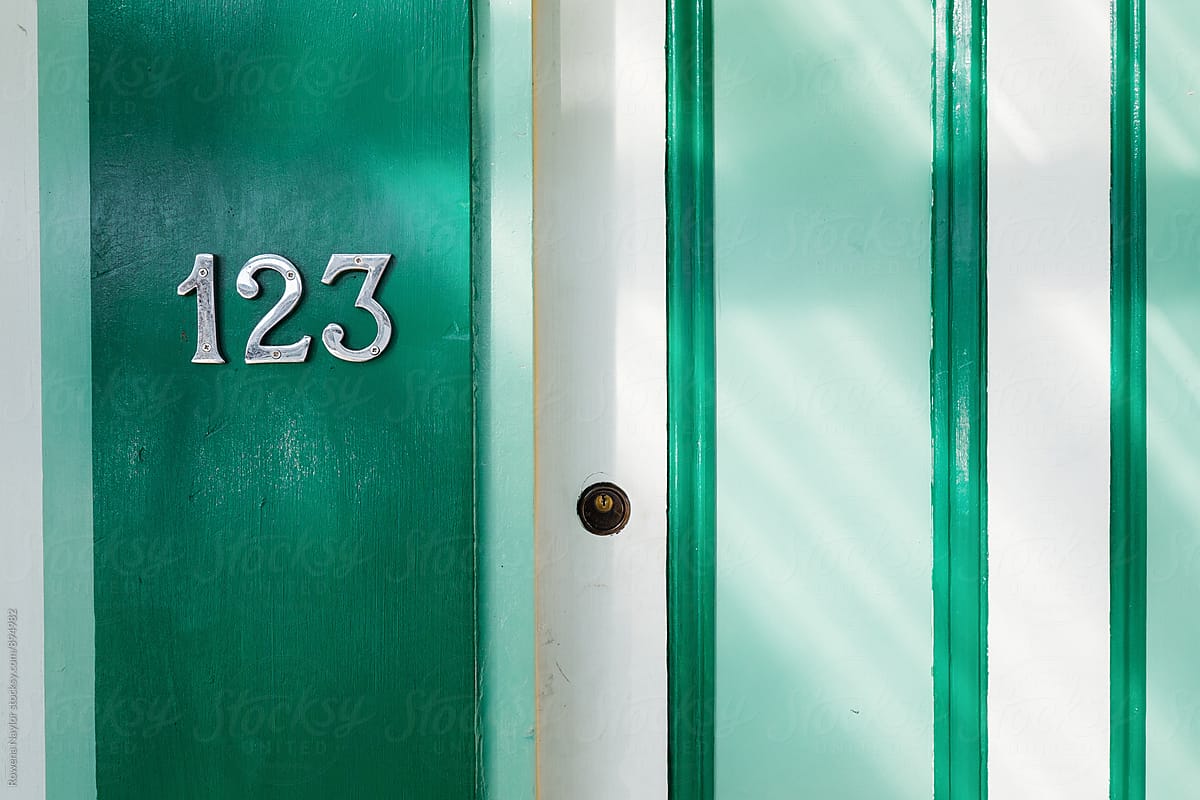 Green door with number 123