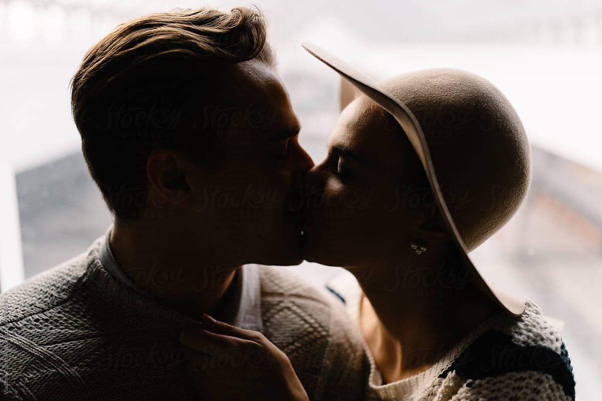 Girl Kisses A Guy In Dark Room By Stocksy Contributor Vladimir Tsarkov Stocksy