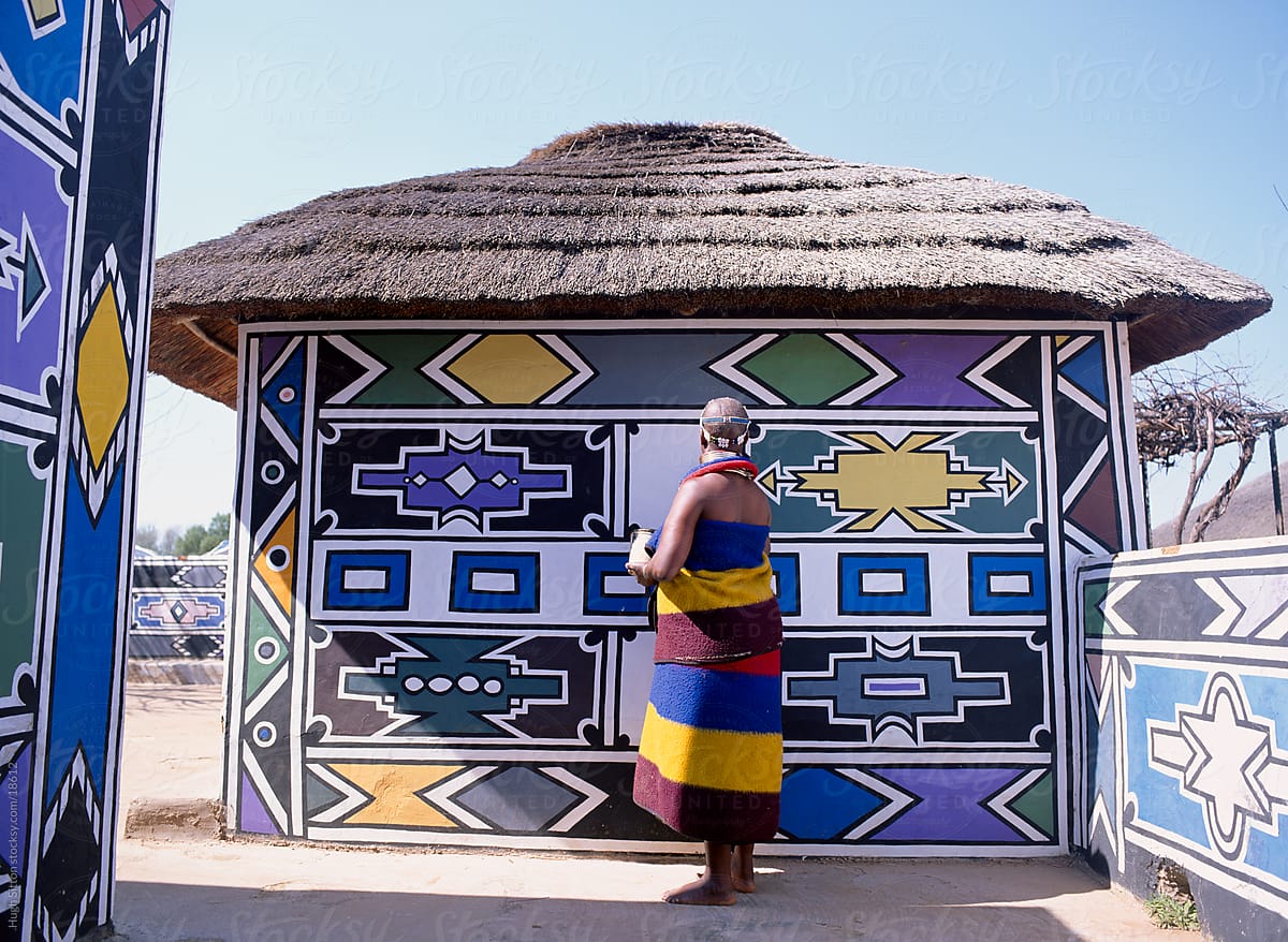 Ndebele woman painting her house. South Africa.