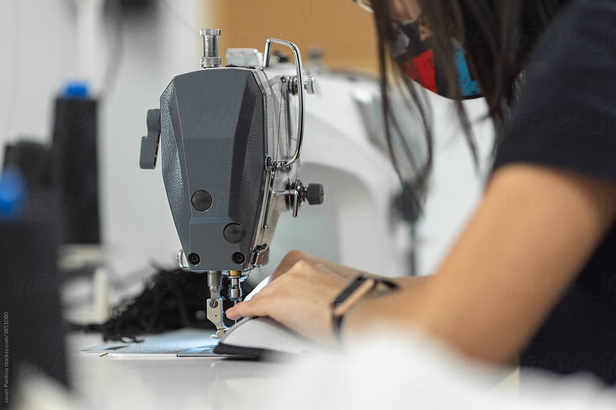 Young woman working with sewing machine