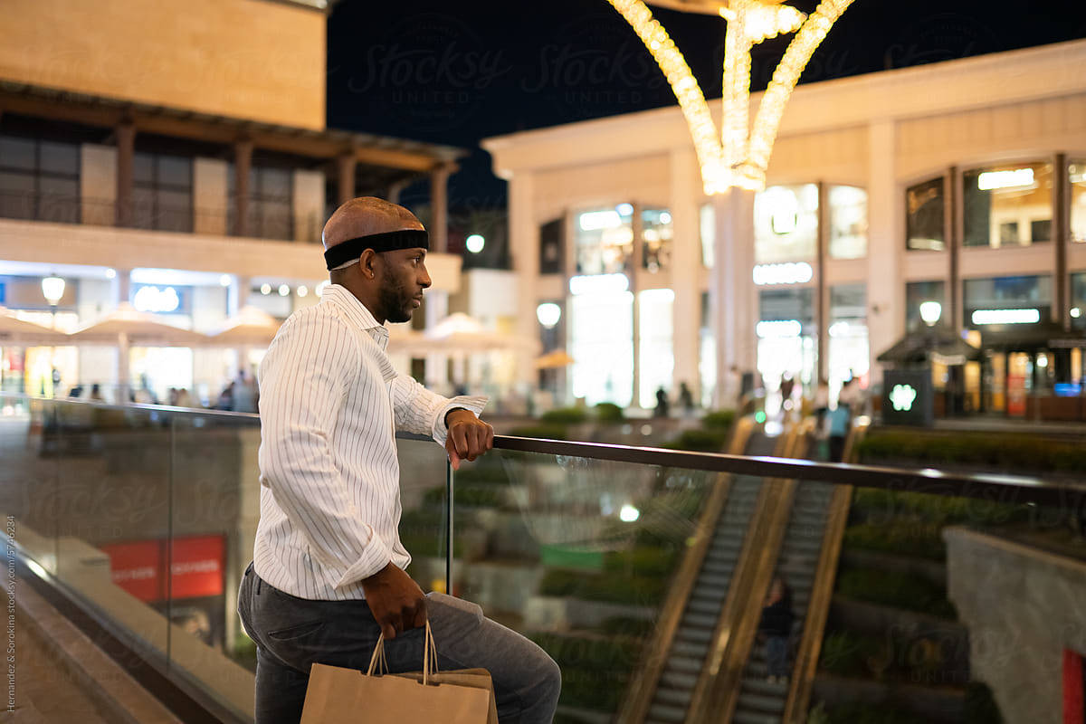 Man After Hair Transplant Holding Shopping Bags Outdoors