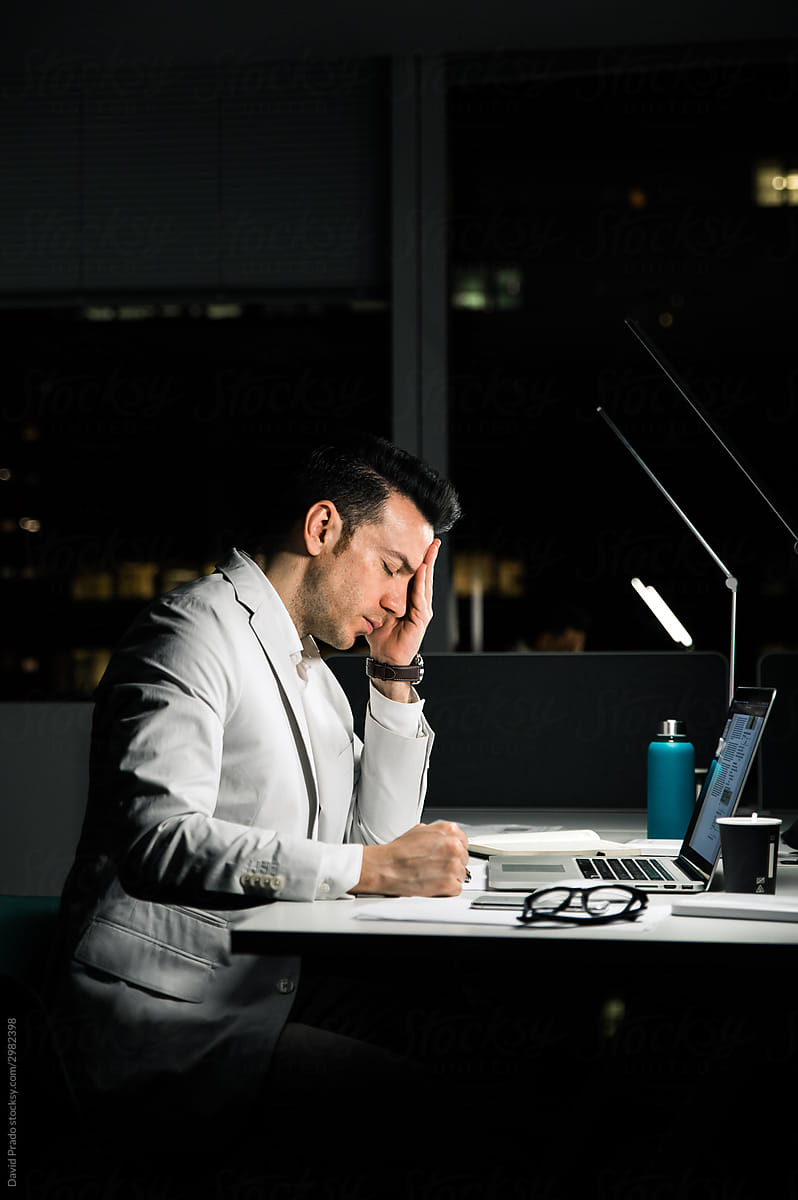 Overworked executive male employee in office