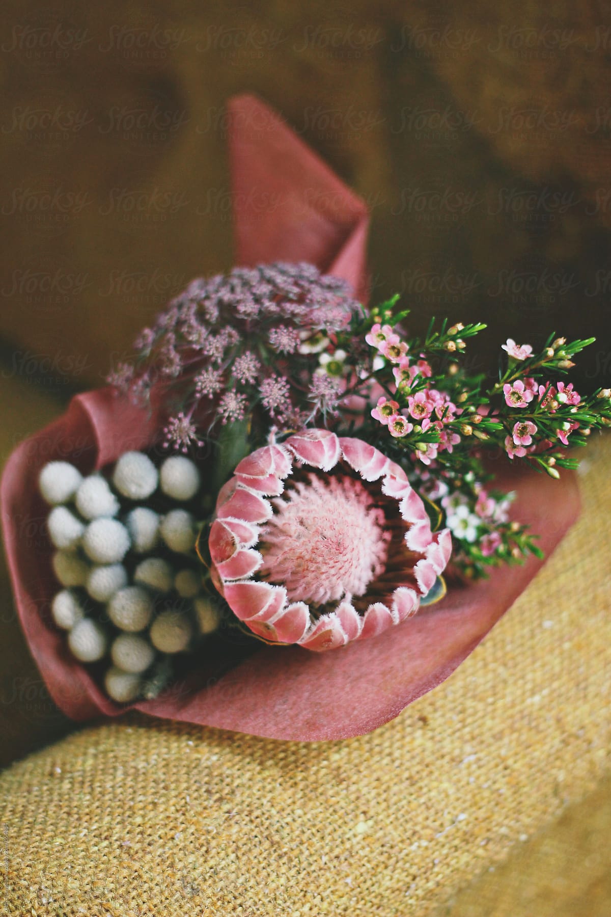 Bouquet of flowers resting on tweed armchair