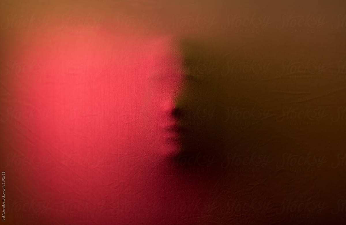 Anonymous human face behind tense fabric texture